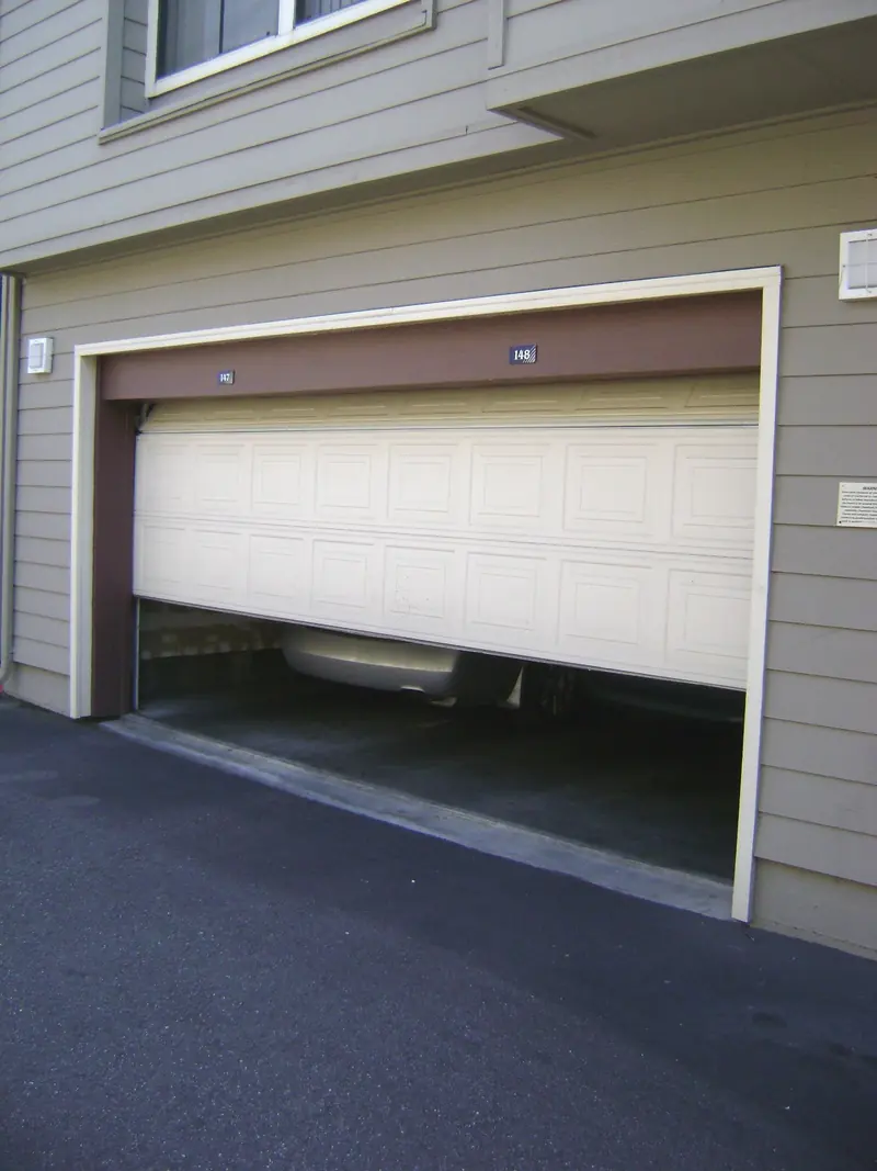 Partly raised sectional garage door and its opening